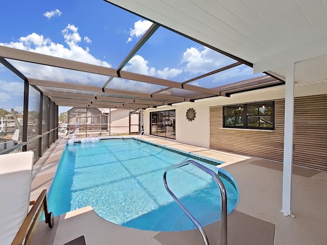 view of pool featuring a patio area and glass enclosure