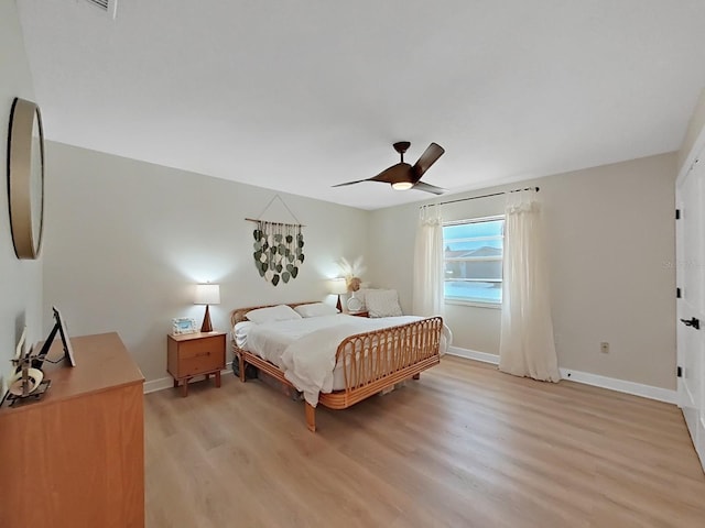 bedroom with light hardwood / wood-style flooring and ceiling fan