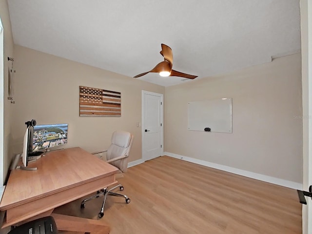 office with light hardwood / wood-style floors and ceiling fan