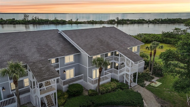 aerial view at dusk with a water view