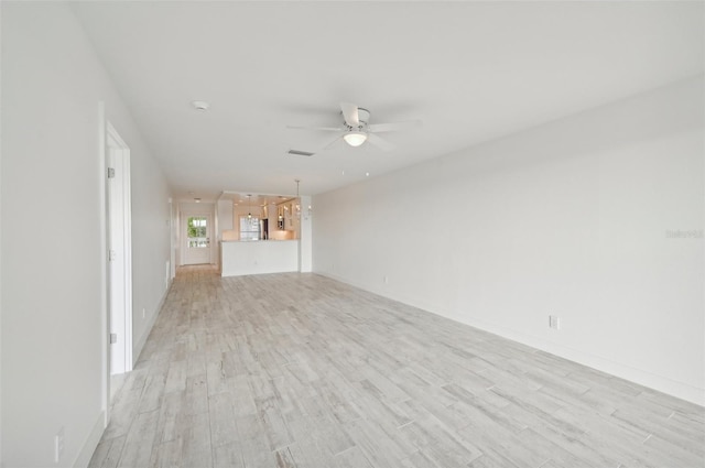 unfurnished living room featuring ceiling fan and light hardwood / wood-style flooring