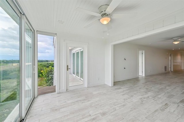 empty room with light hardwood / wood-style flooring and ceiling fan