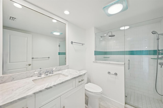 bathroom with an enclosed shower, vanity, and toilet