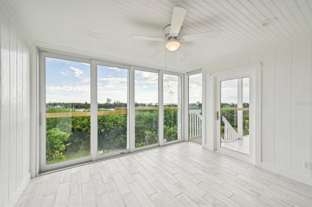 unfurnished sunroom with ceiling fan and plenty of natural light