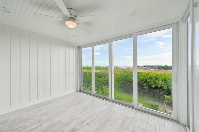 unfurnished sunroom with ceiling fan and a wealth of natural light