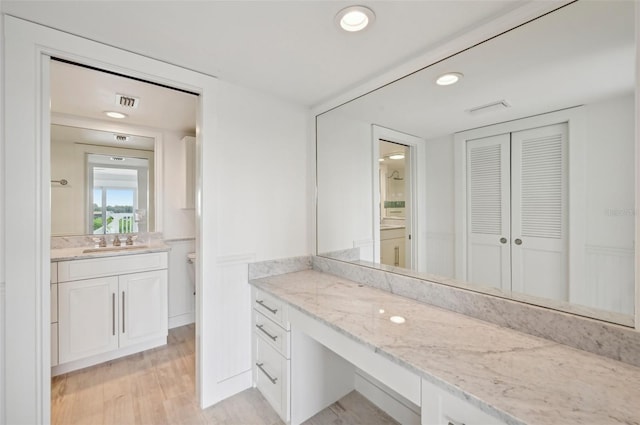 bathroom with wood-type flooring and vanity