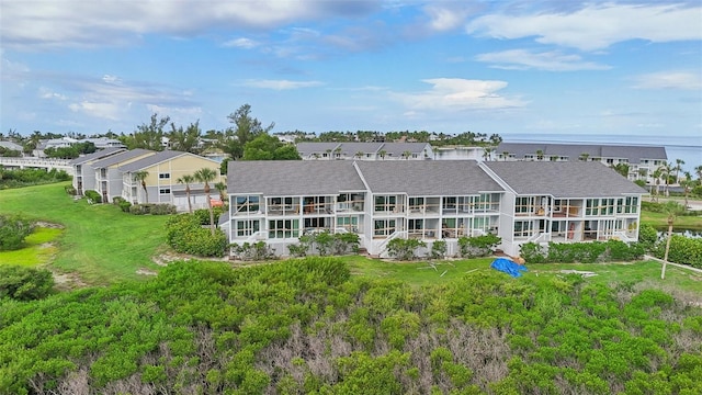 back of house featuring a water view and a yard