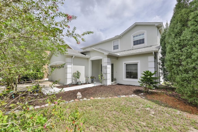 view of property with a front yard and a garage