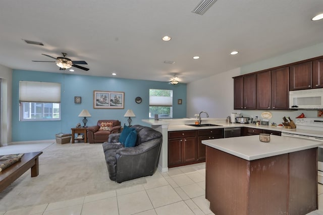 kitchen with a wealth of natural light, sink, electric range, and light tile patterned floors