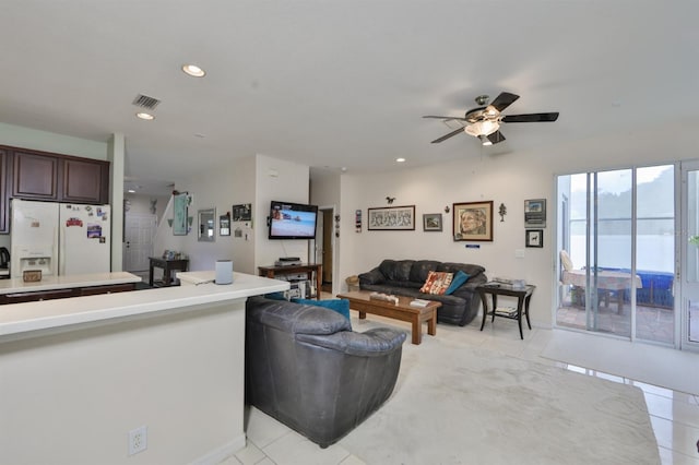 living room featuring light tile patterned floors and ceiling fan