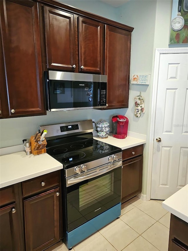 kitchen with appliances with stainless steel finishes and light tile patterned flooring