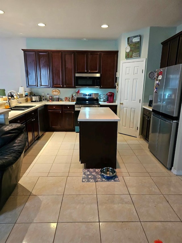 kitchen featuring sink, dark brown cabinets, a center island, stainless steel appliances, and light tile patterned floors