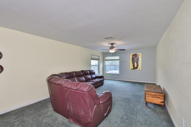 living room with dark carpet, a textured ceiling, and ceiling fan