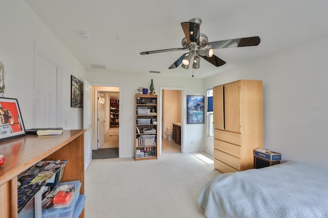 bedroom with ceiling fan, ensuite bathroom, and light colored carpet