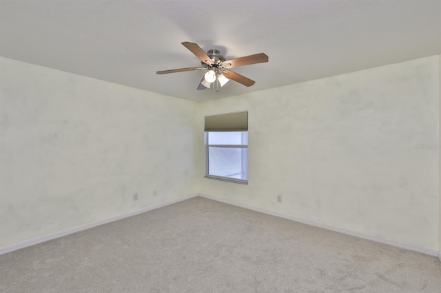 spare room featuring ceiling fan and light colored carpet