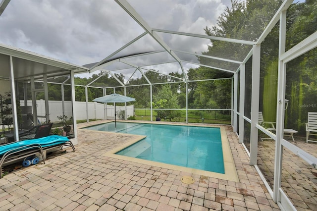 view of pool featuring a patio and glass enclosure