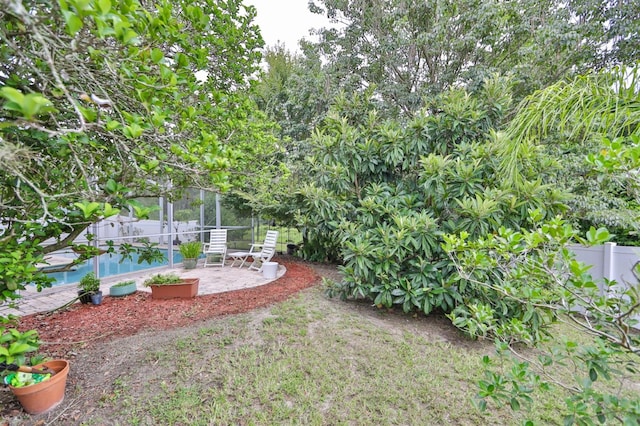 view of yard featuring a patio area and a fenced in pool