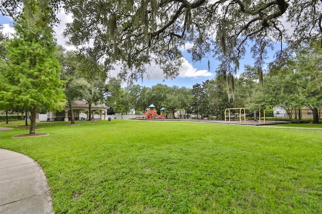 surrounding community with a playground and a lawn