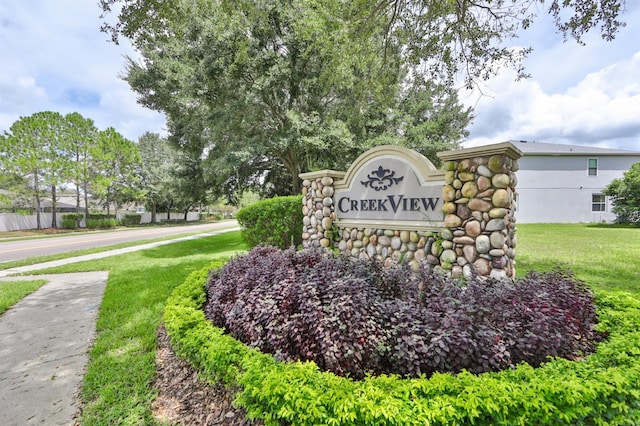 community sign featuring a lawn