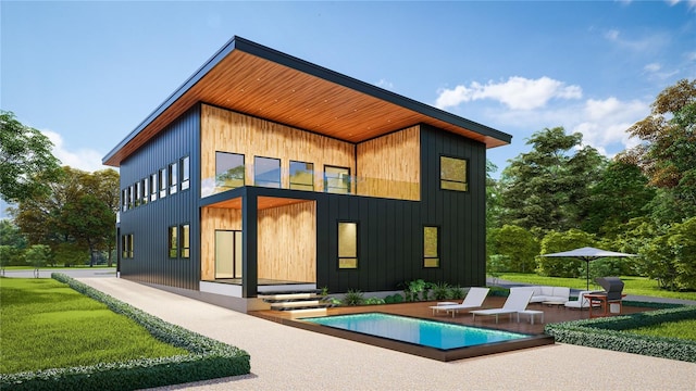 rear view of property featuring a lawn, a patio, and an outdoor living space