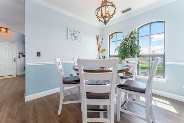 dining space featuring an inviting chandelier, plenty of natural light, dark wood-type flooring, and crown molding