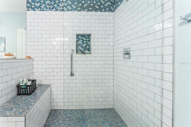 bathroom with tile walls and tiled shower