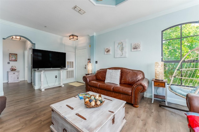 living room featuring wood-type flooring and crown molding