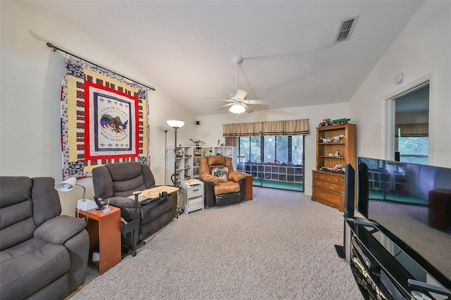 living room with ceiling fan, lofted ceiling, and carpet