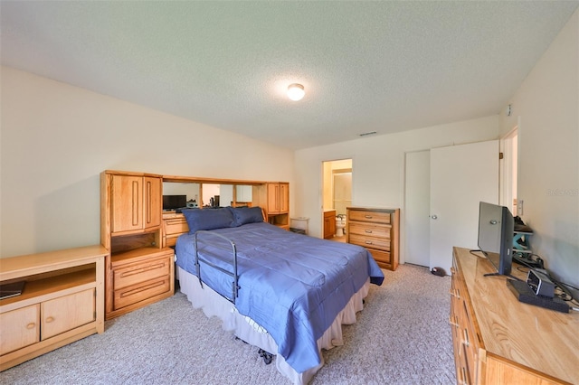 carpeted bedroom with a textured ceiling