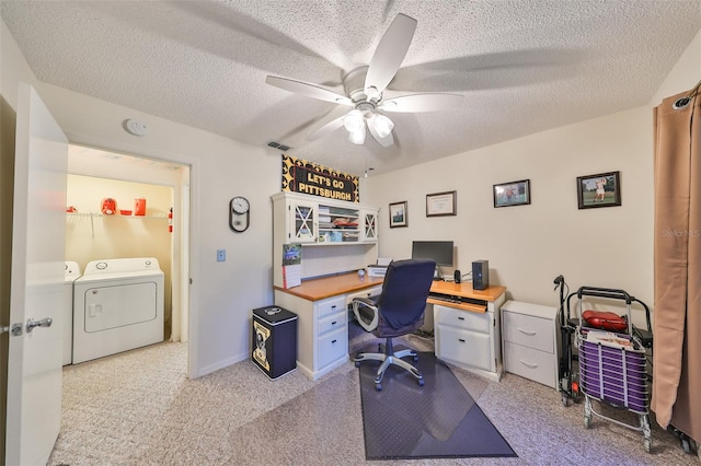 office featuring a textured ceiling, separate washer and dryer, ceiling fan, and light colored carpet