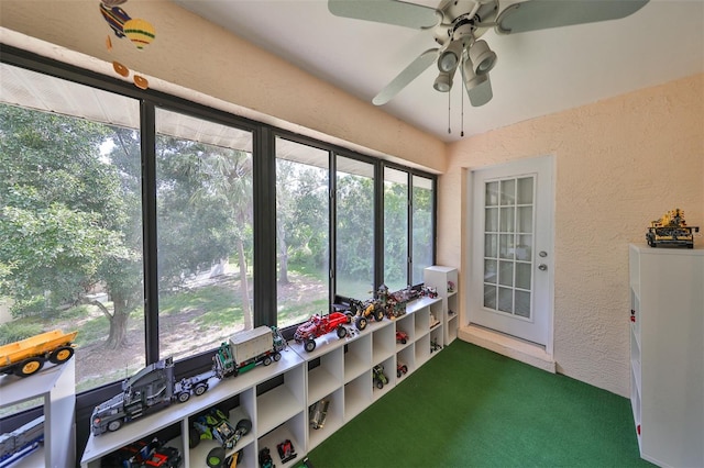 sunroom / solarium featuring ceiling fan