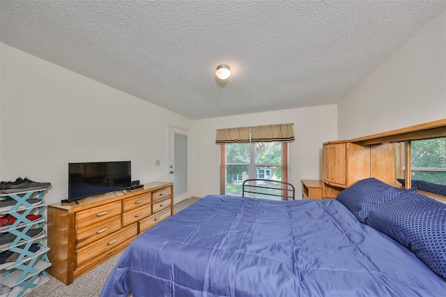 carpeted bedroom featuring a textured ceiling