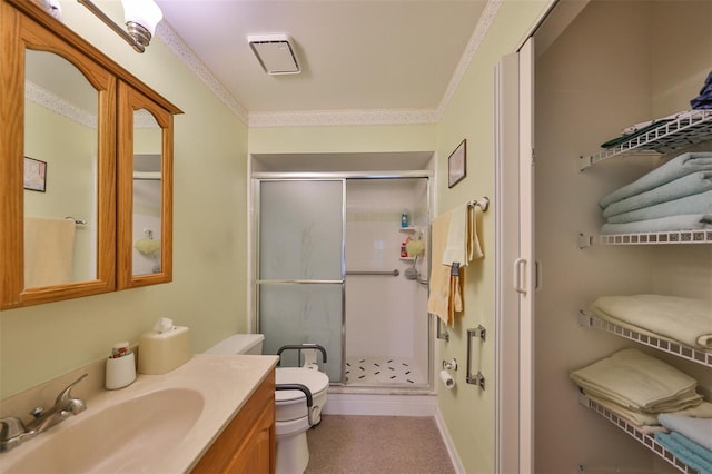 bathroom with vanity, crown molding, an enclosed shower, and toilet