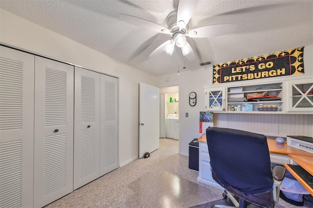 office area featuring washer / clothes dryer, ceiling fan, and a textured ceiling