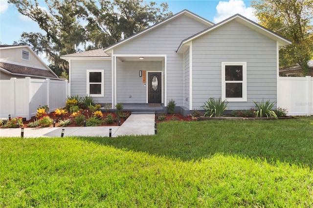 bungalow-style house with a front lawn