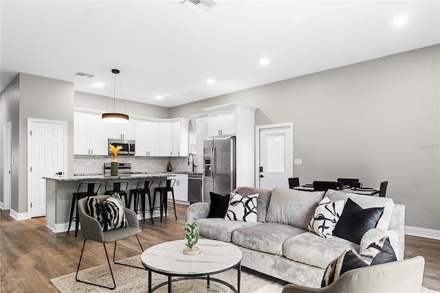 living room featuring dark hardwood / wood-style floors and sink