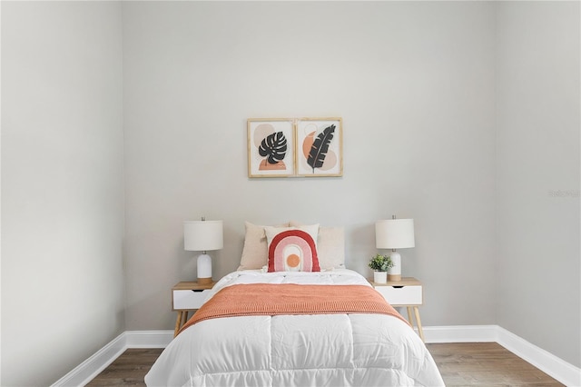 bedroom with dark hardwood / wood-style floors