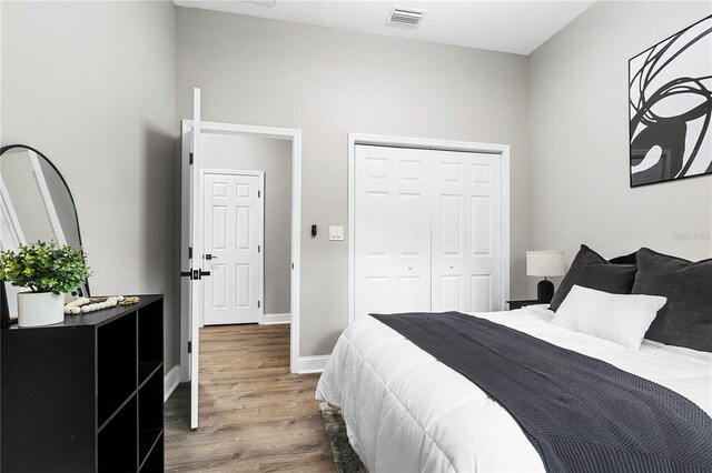 bedroom featuring hardwood / wood-style flooring and a closet