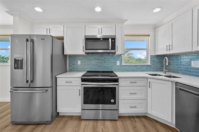 kitchen with white cabinetry, light hardwood / wood-style floors, appliances with stainless steel finishes, and sink