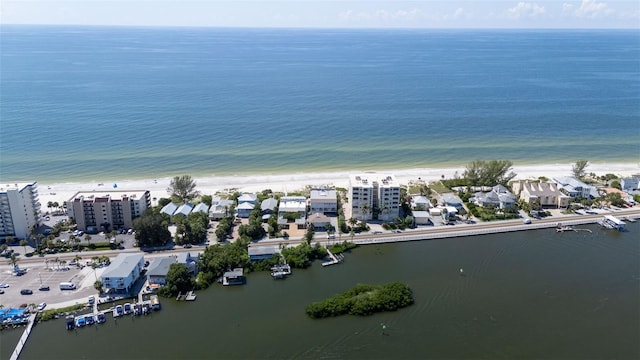 drone / aerial view with a beach view and a water view