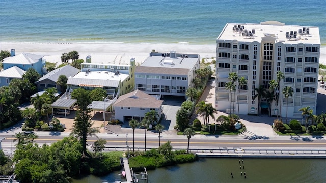 drone / aerial view featuring a water view and a beach view