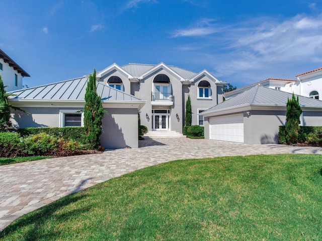 view of front of house with a balcony and a front lawn