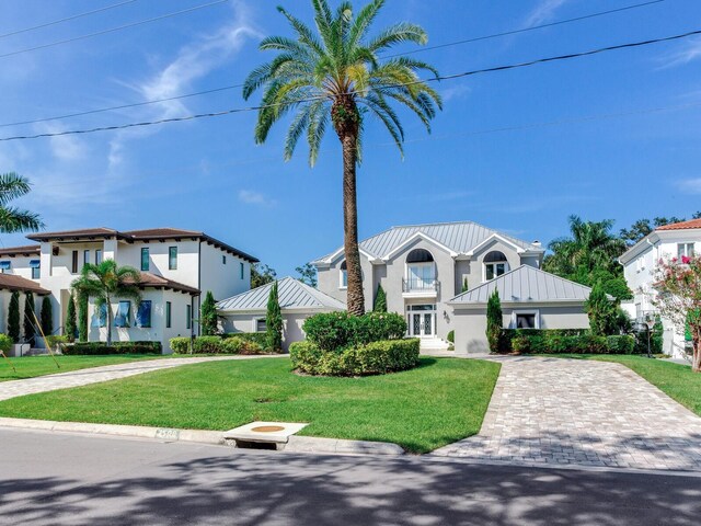 2509 N Dundee St, Tampa, FL 33629 - view of front of house with a standing seam roof, metal roof, a front yard, stucco siding, and driveway