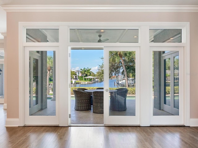 doorway to outside with a water view, ornamental molding, french doors, and hardwood / wood-style floors