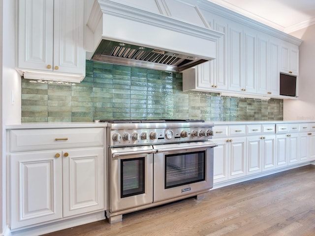 2509 N Dundee St, Tampa, FL 33629 - kitchen with range with two ovens, custom range hood, white cabinetry, light wood-style floors, and light countertops