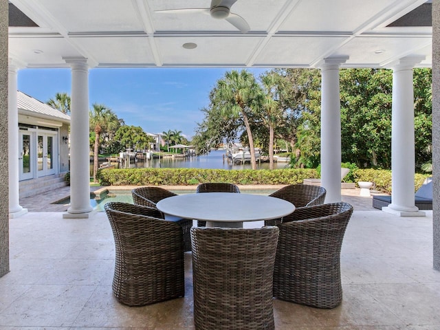 view of patio with french doors, a water view, and ceiling fan