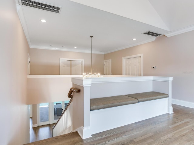 stairway featuring crown molding and hardwood / wood-style floors