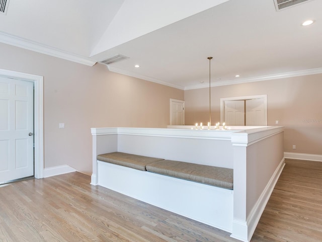 interior space with ornamental molding, light hardwood / wood-style flooring, and a notable chandelier