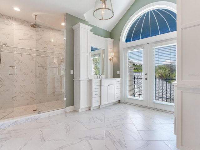 bathroom with vanity, french doors, a shower with shower door, and lofted ceiling