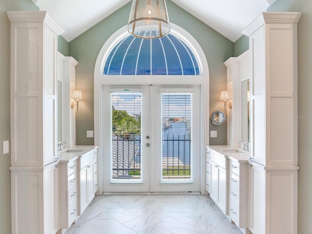 entryway with lofted ceiling, french doors, and sink